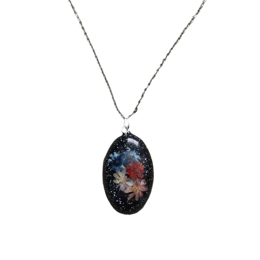 Experience the beauty of nature with our Necklace! Made with a durable stainless steel link chain and a stunning resin pendant filled with dried flowers, this 18.5 inch necklace adds a touch of elegance to any outfit. Perfect for nature lovers and those who appreciate unique jewelry pieces.