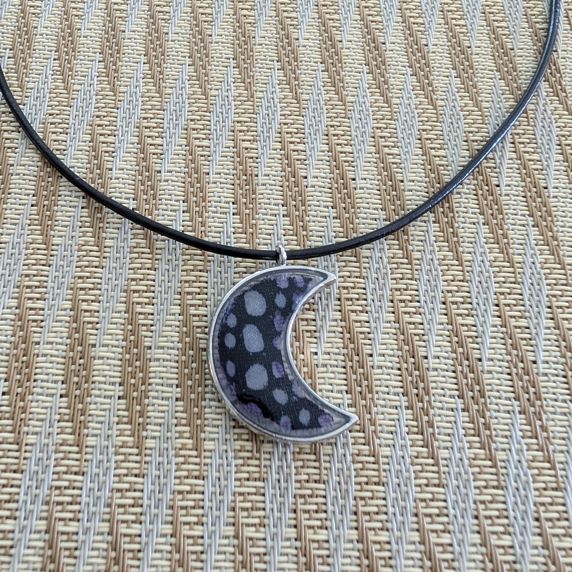 This stunning necklace features an 18-inch black leather cord with a resin silver moon pendant. The extension chain adds an extra 2 inches for the perfect fit. Lightweight at only 0.2 oz, this necklace will elevate any outfit. Feel passionate and inspired wearing this beautiful piece.