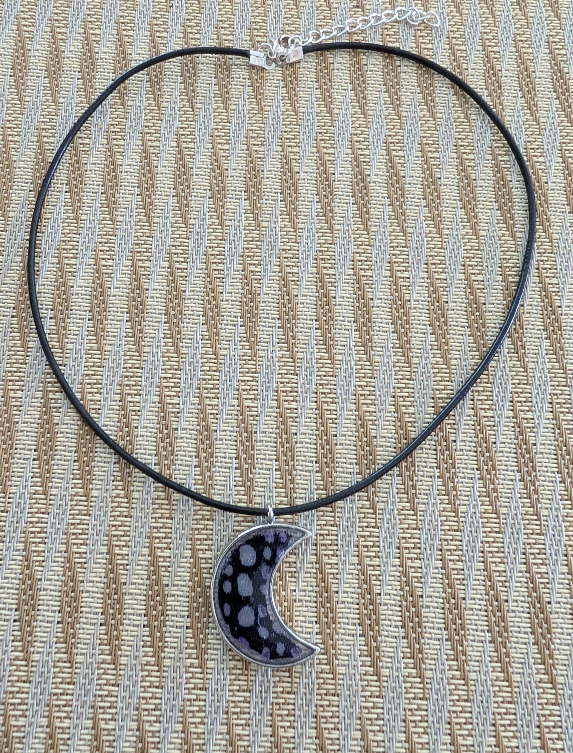 This stunning necklace features an 18-inch black leather cord with a resin silver moon pendant. The extension chain adds an extra 2 inches for the perfect fit. Lightweight at only 0.2 oz, this necklace will elevate any outfit. Feel passionate and inspired wearing this beautiful piece.