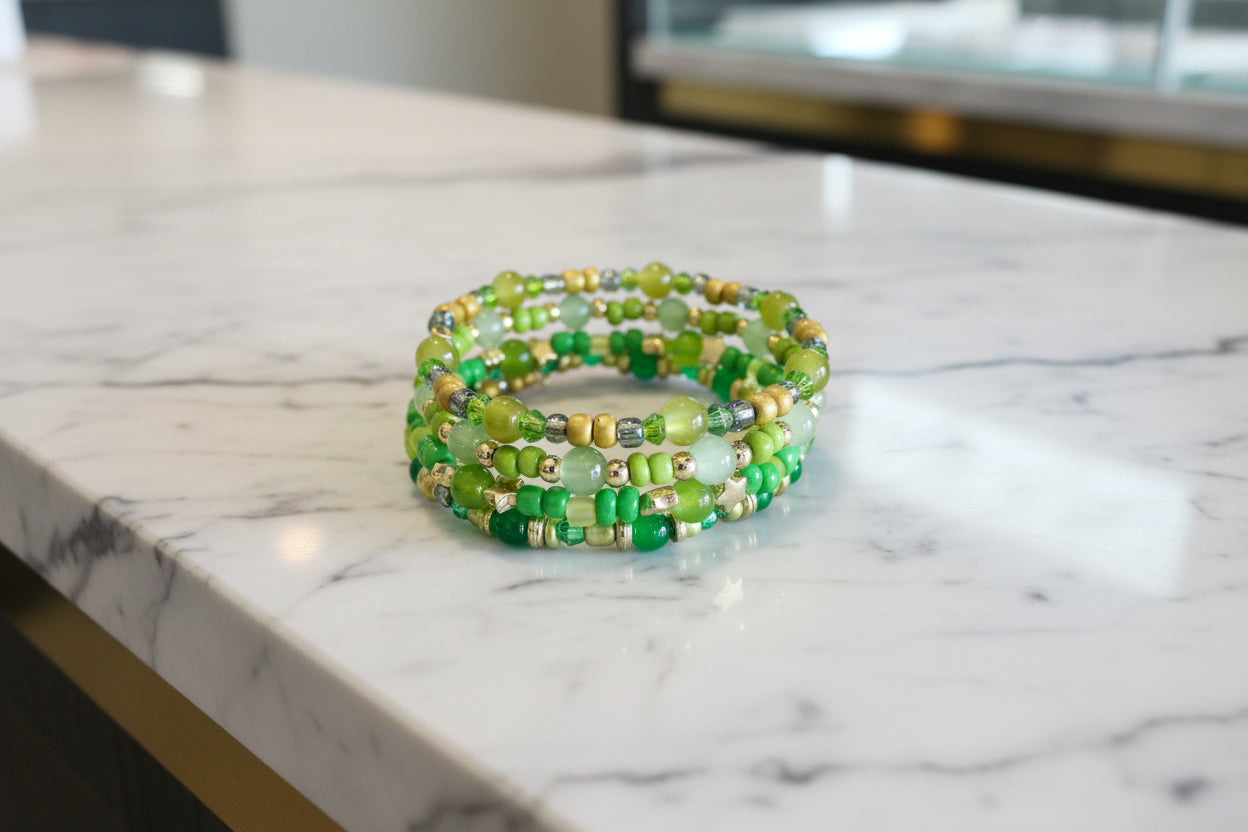 Elevate your style with our stunning Bracelet - a 4 coil piece featuring vibrant 6mm green glass and seed beads, accented with elegant gold spacer beads. The unique memory wire design ensures a perfect fit every time. Make a statement and add a touch of luxury to any outfit!