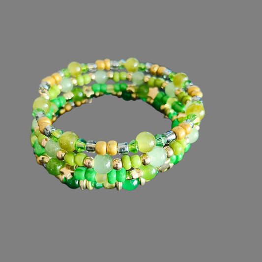 Elevate your style with our stunning Bracelet - a 4 coil piece featuring vibrant 6mm green glass and seed beads, accented with elegant gold spacer beads. The unique memory wire design ensures a perfect fit every time. Make a statement and add a touch of luxury to any outfit!
