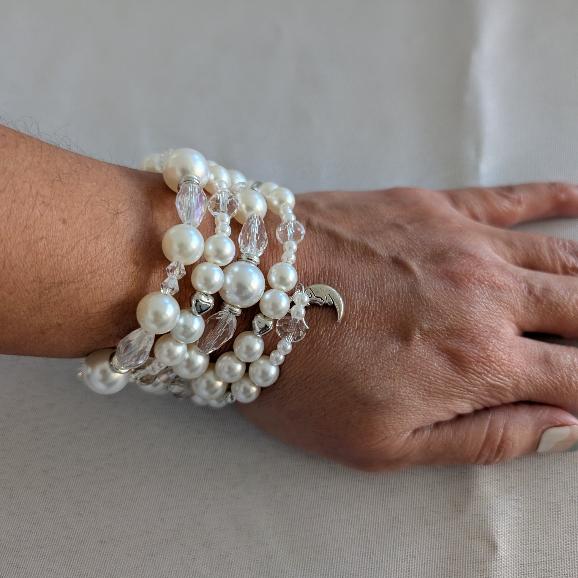 Experience elegance with our Memory Wire Bracelet featuring white pearl beads and silver spacer beads. Enhance any outfit with this versatile and stylish piece. Feel confident and glamorous with every wear!