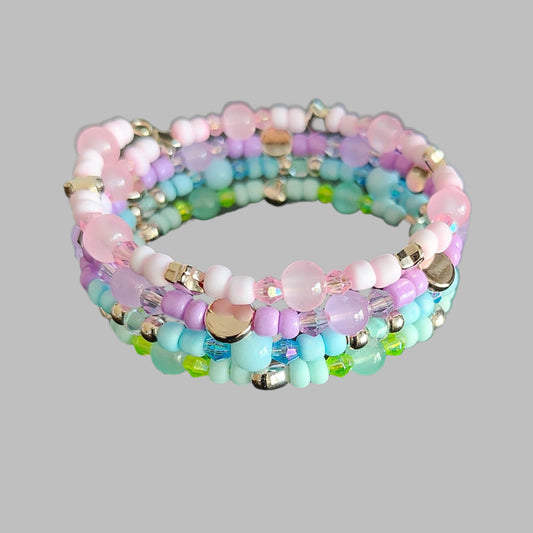 Embrace the beauty of the pastel tones with our 4 coil memory wire bracelet. With beads in shades of pink, purple, blue, and green, accented by rose gold spacer beads, this bracelet is a must-have for any jewelry lover. Feel confident and stylish with this unique and versatile accessory!