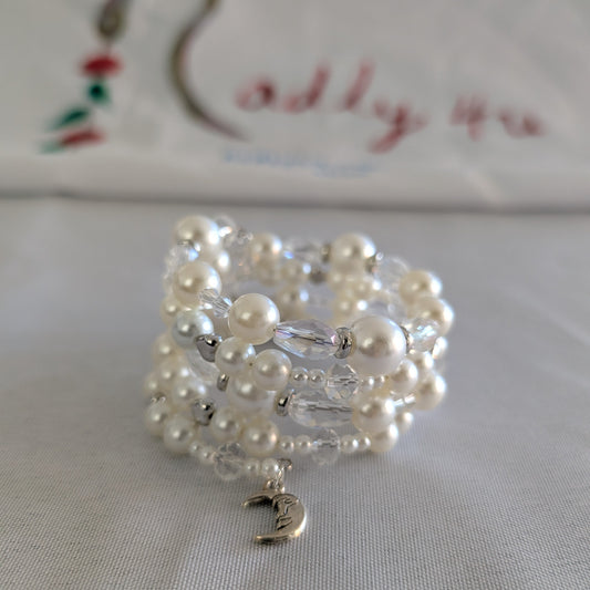 Experience elegance with our Memory Wire Bracelet featuring white pearl beads and silver spacer beads. Enhance any outfit with this versatile and stylish piece. Feel confident and glamorous with every wear!