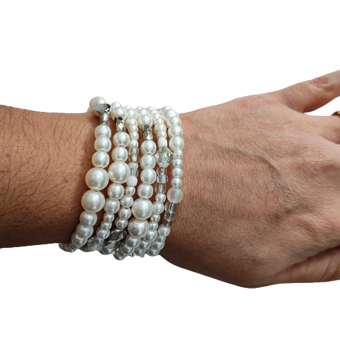 Experience elegance with our Memory Wire Bracelet featuring white pearl beads and silver spacer beads. Enhance any outfit with this versatile and stylish piece. Feel confident and glamorous with every wear!