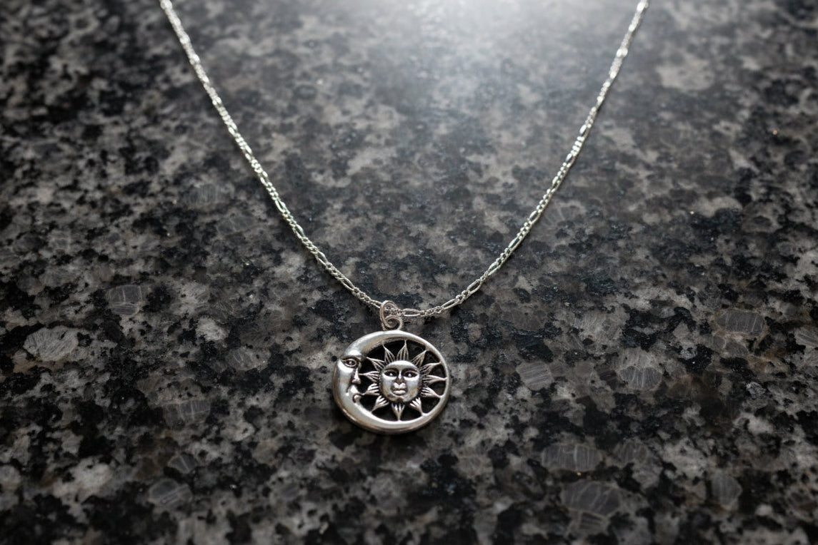 This beautiful 925 silver figaro necklace is perfect for any style. The 21 inch chain drapes perfectly around the neck with a stunning sun and moon charm to complete the look. Enjoy the delicate shine of this necklace as you go about your day. A must-have addition to any jewelry collection!