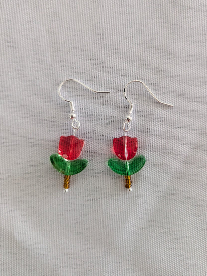 Delicate crystal and seed beads form an enchanting tulip design, suspended from hypoallergenic 925 sterling silver hooks. These lightweight earrings measure just 1.5 inches, making them perfect for everyday elegance or layering with other pieces. At only 0.1 oz, they're comfortable enough to wear all day without fatigue. The shimmering bead work catches light beautifully, adding a touch of sparkle and sophistication to any outfit. Ideal for those who appreciate handcrafted jewelry with timeless appeal.