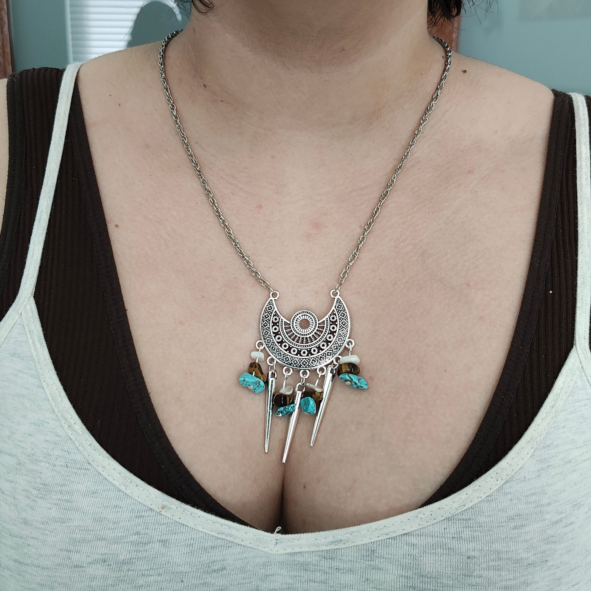 Elevate your style with our stunning Necklace - 22 inches Antique Chandelier Charm. Adorned with sparkling crystal beads and vintage cone shape dangles, it exudes elegance and charm. The stainless steel chain adds durability and a touch of modernity. Make a statement with this unique accessory!