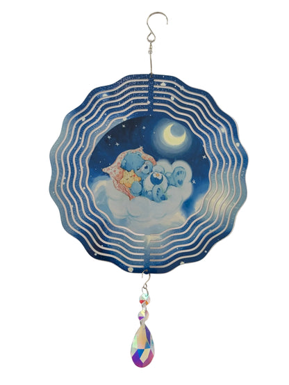 Bring whimsical charm to your outdoor space with this delightful 10-inch wind spinner showcasing Bedtime Care Bear on both sides. As it spins gracefully, stunning 4-inch teardrop crystal prisms dance with light, casting rainbow sparkles across your garden. Crafted from lightweight yet robust aluminum with a protective powder-coated finish, this spinner laughs in the face of rust and corrosion. The UV-treated image stays vibrant and cheerful through countless sunny days. Safe, smooth edges and hassle-free se