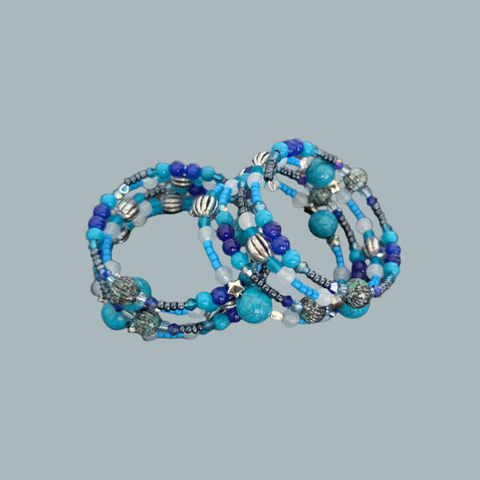 Add a touch of sophistication with this 4-coil memory wire bracelet featuring striking blue and silver beads. Its flexible design ensures a perfect fit for any wrist, while the shimmering silver accents enhance its elegant appeal. Ideal for both casual and formal occasions, this bracelet offers effortless style and lasting comfort.