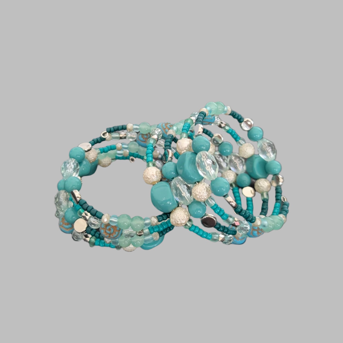 Elevate your style with this stunning 4-coil memory wire bracelet featuring a harmonious blend of turquoise, white, and crystal beads. Its flexible design ensures a comfortable fit for any wrist, while the sparkling crystals add a touch of elegance to any outfit. Perfect for layering or wearing alone, this bracelet effortlessly combines durability with eye-catching beauty.