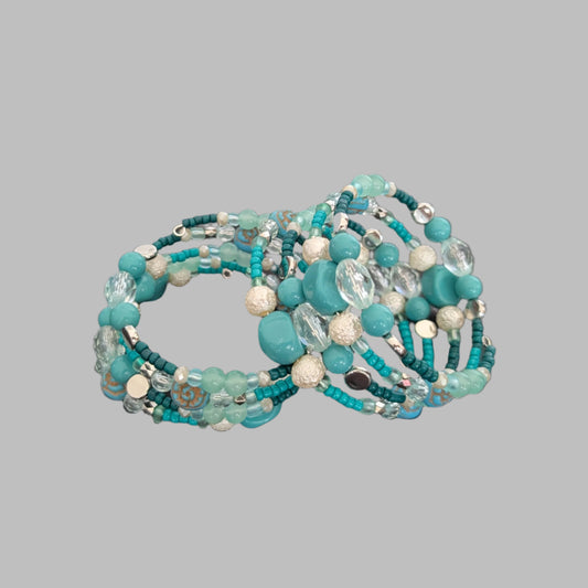 Elevate your style with this stunning 4-coil memory wire bracelet featuring a harmonious blend of turquoise, white, and crystal beads. Its flexible design ensures a comfortable fit for any wrist, while the sparkling crystals add a touch of elegance to any outfit. Perfect for layering or wearing alone, this bracelet effortlessly combines durability with eye-catching beauty.
