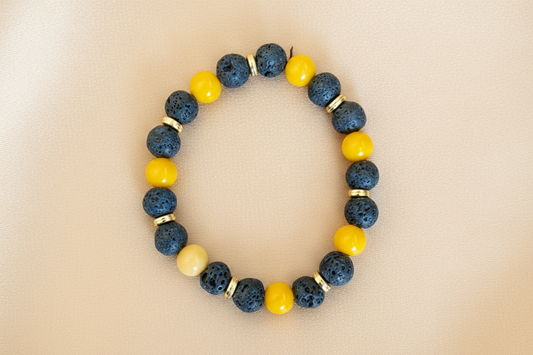 Bracelet - Elastic black volcanic beads and yellow glass beads with gold spacer beads