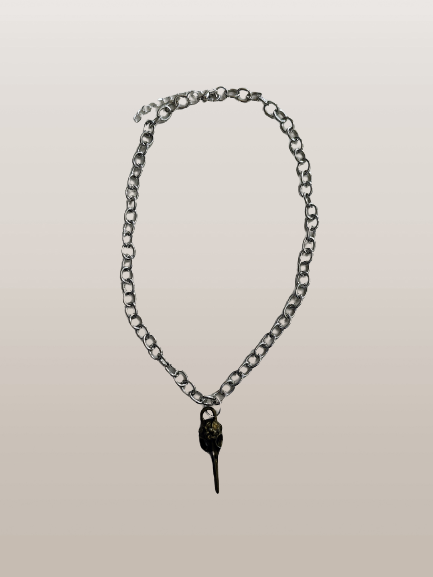 Add some edgy style to your look with our 16" silver chain necklace featuring a unique bronze raven skull head charm. Stand out from the flock with this bold and playful accessory.