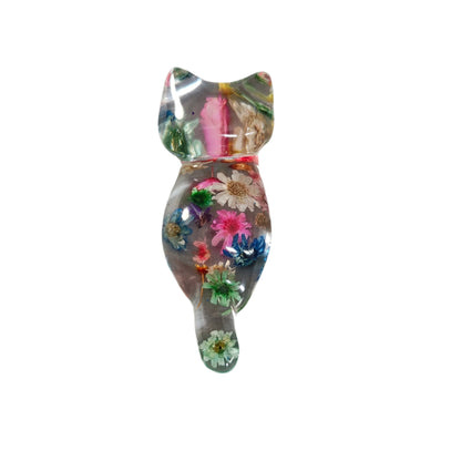 Add some purrfect charm to your home with our playful "Knickknack" resin cat trinket. This small, clear feline is adorned with delicate flowers, making it both stylish and quirky. A unique addition to any knickknack collection.