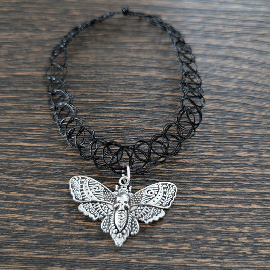 Black elastic stretch choker necklace with antique silver moth charm, gothic boho style jewelry.
