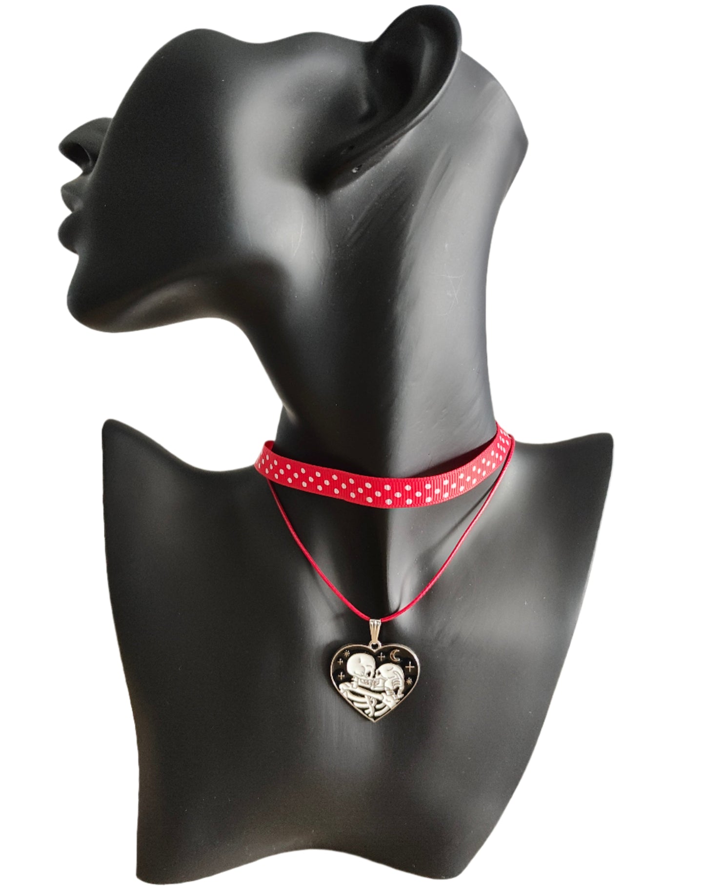 Add a touch of edgy sophistication to any look with our Choker Necklace. Made of polka dot fabric ribbon, this necklace features one durable polyester strand and a black skeleton heart charm. Perfect for those looking to make a statement.