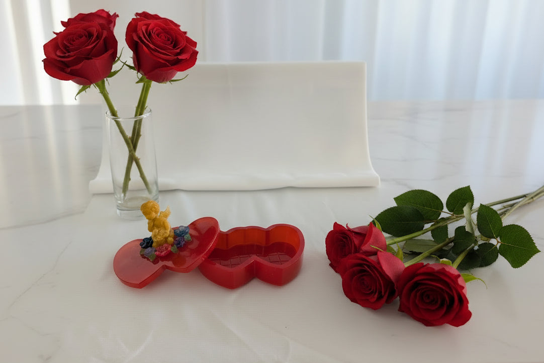 Handcrafted with premium epoxy resin, this stunning double heart trinket box showcases an angelic figure surrounded by delicate flowers on its lid. The smooth, glass-like finish creates an elegant display piece that's as beautiful to look at as it is functional. Measuring 4x6 inches with a 4-inch height and 1-inch dish depth, it's perfectly sized for storing rings, earrings, bracelets, and cherished keepsakes. The durable resin construction ensures your jewelry stays protected while adding a touch of artist