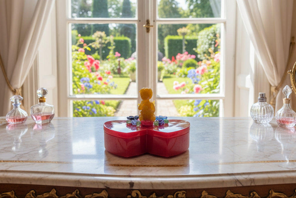 Handcrafted with premium epoxy resin, this stunning double heart trinket box showcases an angelic figure surrounded by delicate flowers on its lid. The smooth, glass-like finish creates an elegant display piece that's as beautiful to look at as it is functional. Measuring 4x6 inches with a 4-inch height and 1-inch dish depth, it's perfectly sized for storing rings, earrings, bracelets, and cherished keepsakes. The durable resin construction ensures your jewelry stays protected while adding a touch of artist