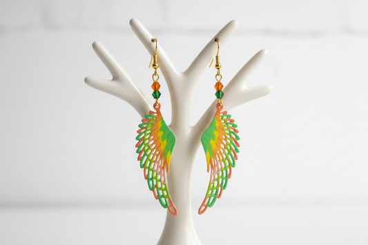Colorful wing-shaped earrings on a white stand with a light gray background