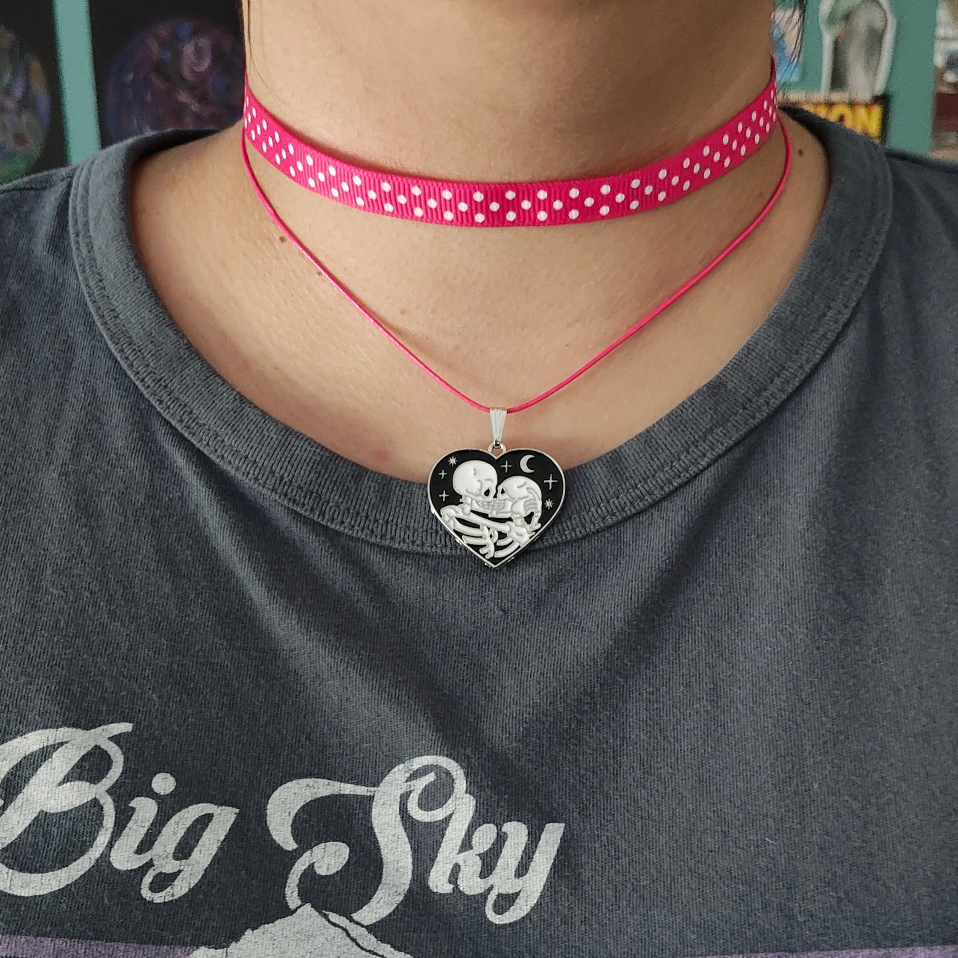 Add a touch of edgy sophistication to any look with our Choker Necklace. Made of polka dot fabric ribbon, this necklace features one durable polyester strand and a black skeleton heart charm. Perfect for those looking to make a statement.