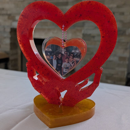 Transform your favorite photo into a one-of-a-kind keepsake with this custom epoxy resin knickknack. Hand-crafted to showcase your image nestled between two hands forming a heart, this charming piece features a smooth, glass-like finish that's built to last.