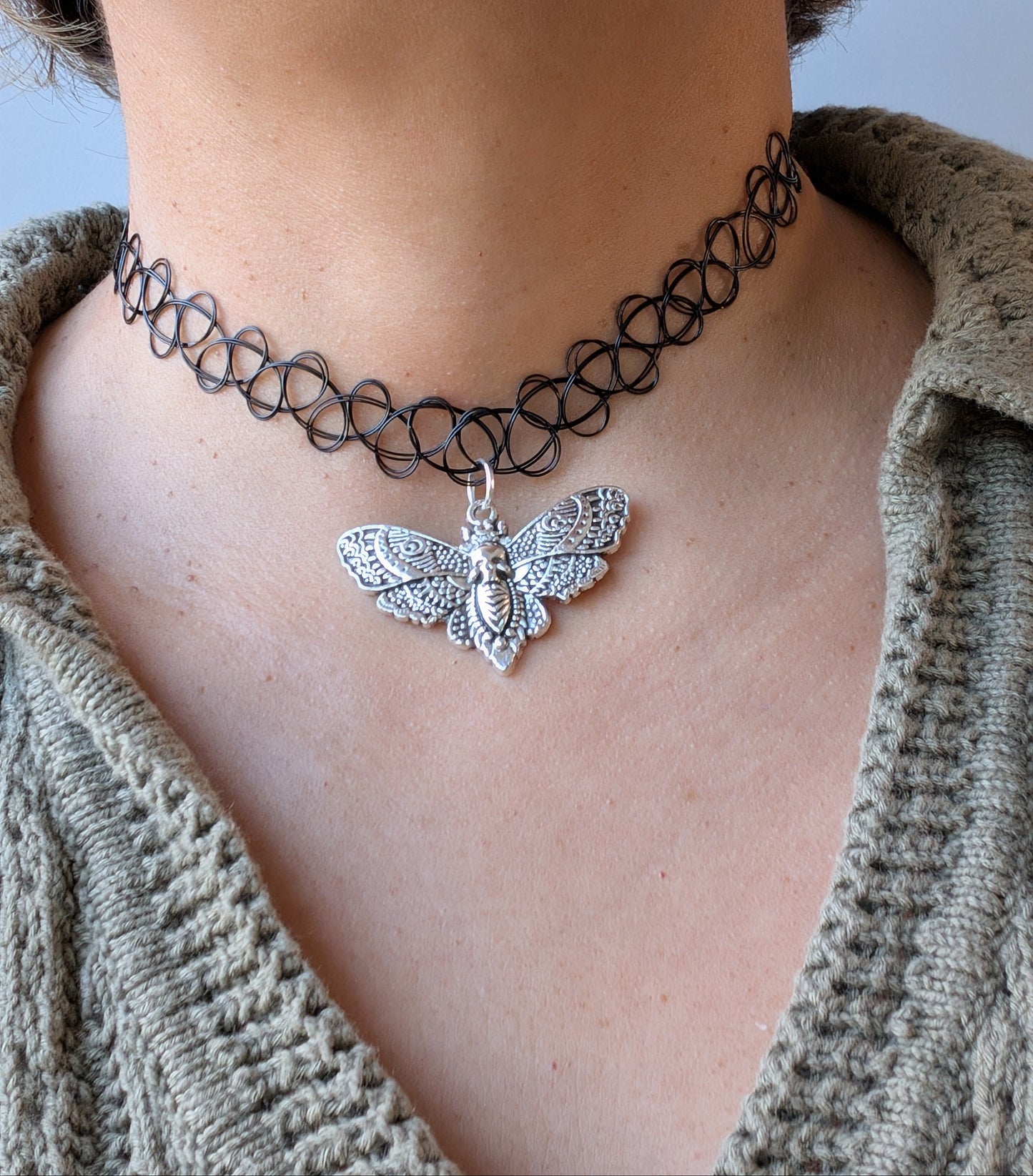 Black elastic stretch choker necklace with antique silver moth charm, gothic boho style jewelry.
