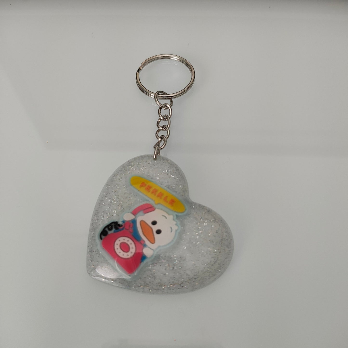 Elevate your style and show off your love for cute with our 3D resin pekkle heart keychain! Made from high-quality materials, this keychain adds a touch of whimsy to your everyday essentials. Its 3D design and durable construction make it the perfect accessory for any bag or set of keys. Spread the love with our charming keychain!