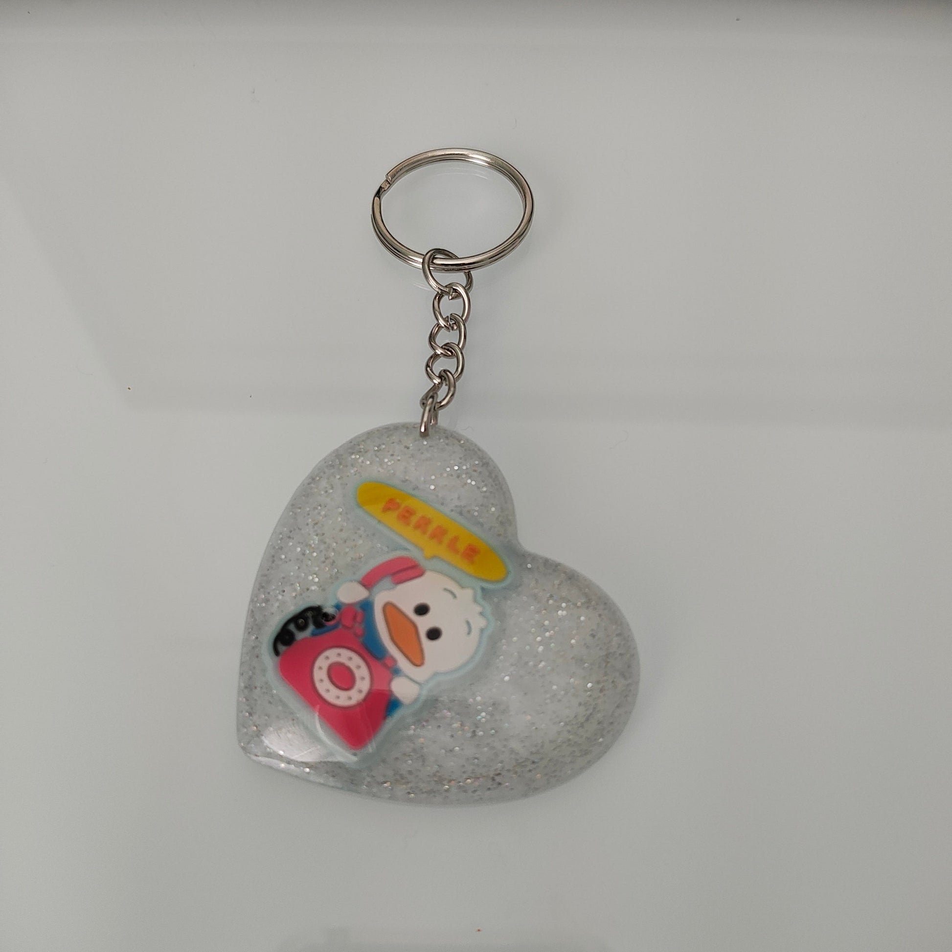 Elevate your style and show off your love for cute with our 3D resin pekkle heart keychain! Made from high-quality materials, this keychain adds a touch of whimsy to your everyday essentials. Its 3D design and durable construction make it the perfect accessory for any bag or set of keys. Spread the love with our charming keychain!