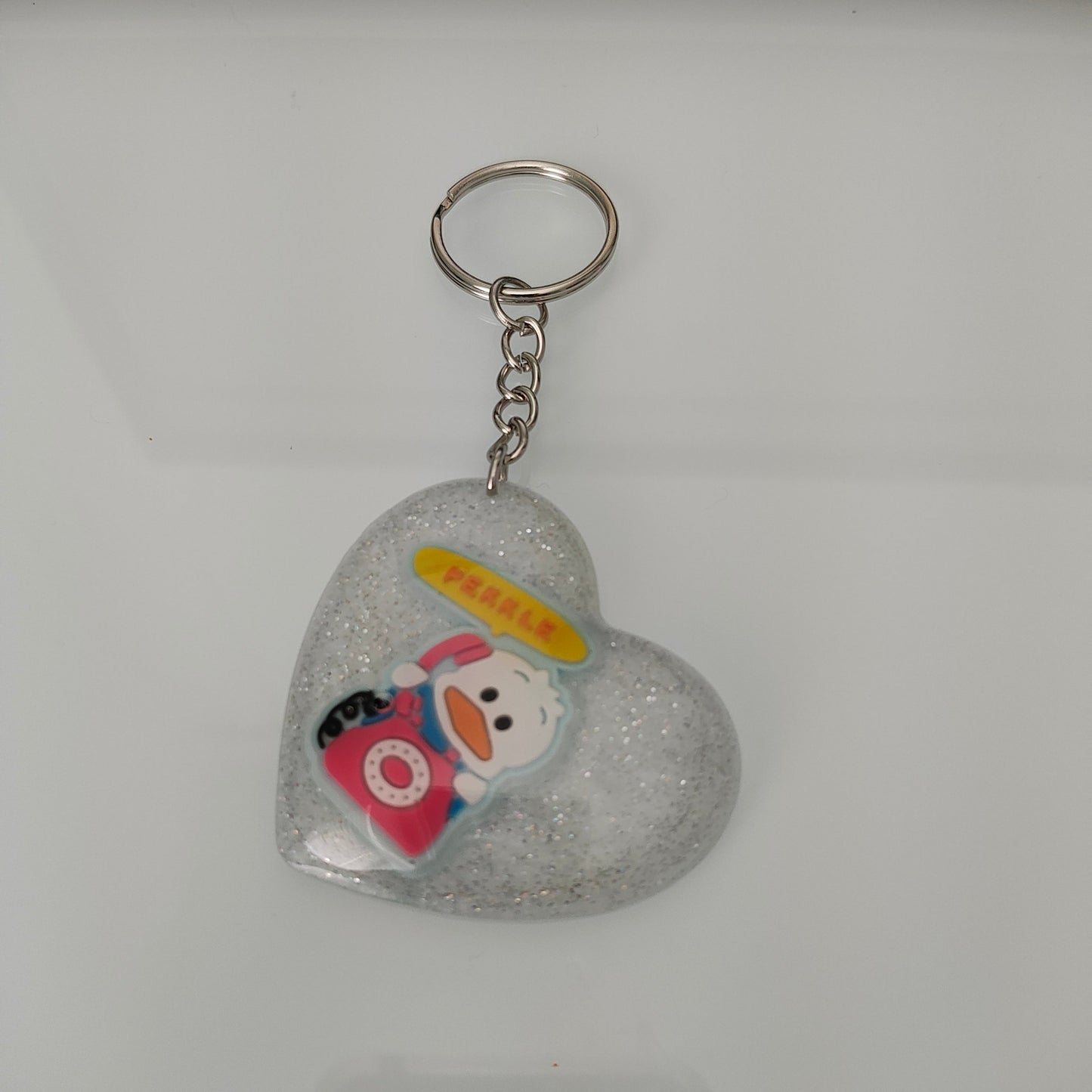 Elevate your style and show off your love for cute with our 3D resin pekkle heart keychain! Made from high-quality materials, this keychain adds a touch of whimsy to your everyday essentials. Its 3D design and durable construction make it the perfect accessory for any bag or set of keys. Spread the love with our charming keychain!
