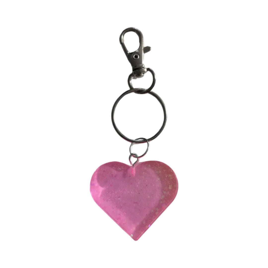 Show your heart is in the right place with this one-of-a-kind keychain! Its resin heart design is as unique as it is eye-catching – no two are alike. Plus, it's lightweight, making it perfect for carrying everywhere you go. Get your keychain on!