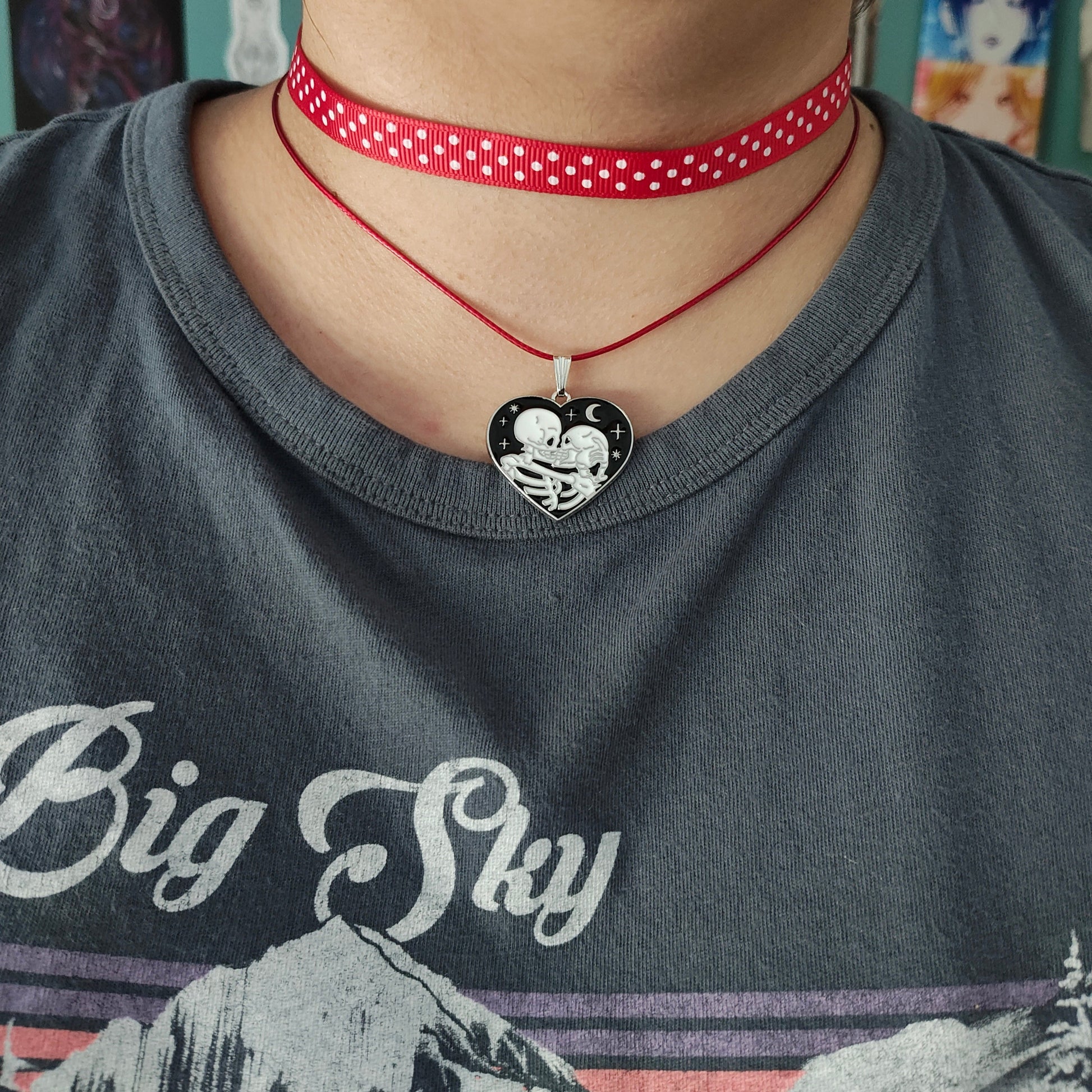 Add a touch of edgy sophistication to any look with our Choker Necklace. Made of polka dot fabric ribbon, this necklace features one durable polyester strand and a black skeleton heart charm. Perfect for those looking to make a statement.