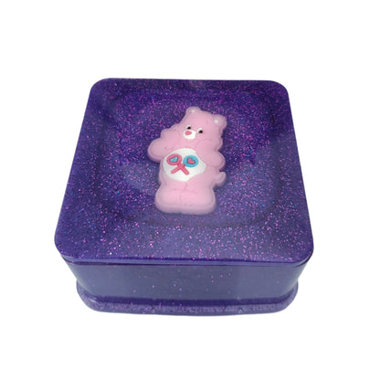Elevate your jewelry storage game with our Knickknack resin square box. The character lid adds personality to this functional piece, keeping your treasures organized and protected. Made with high-quality resin, it's durable and long-lasting. Add a touch of charm to your vanity or dresser.