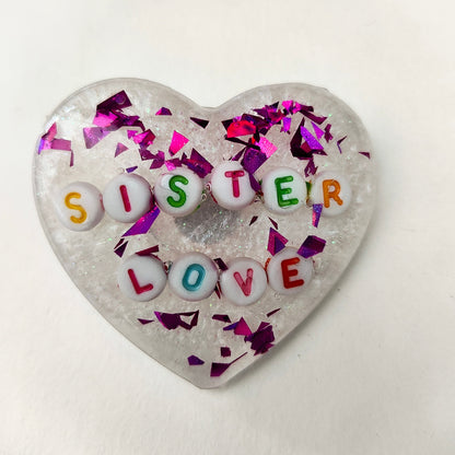 Wear your heart on your sleeve (or anywhere!) with this playful 3D resin heart pin. The silver butterfly clutch adds a touch of whimsy to this lightweight 0.40 oz accessory, measuring 1.75 x 2 in. Show your love with a pinch of quirkiness.