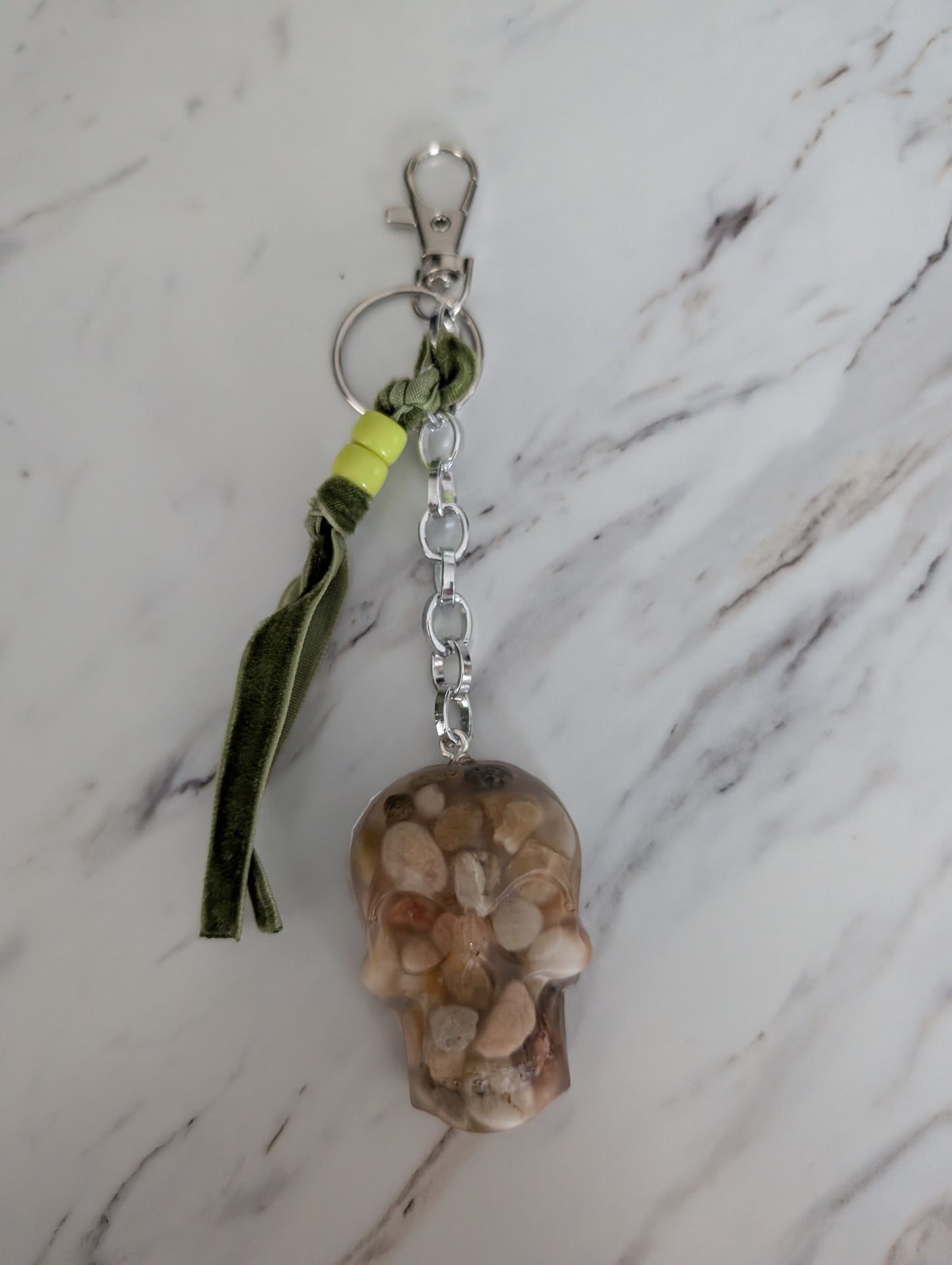 Keychain with natural stone design on a marble surface