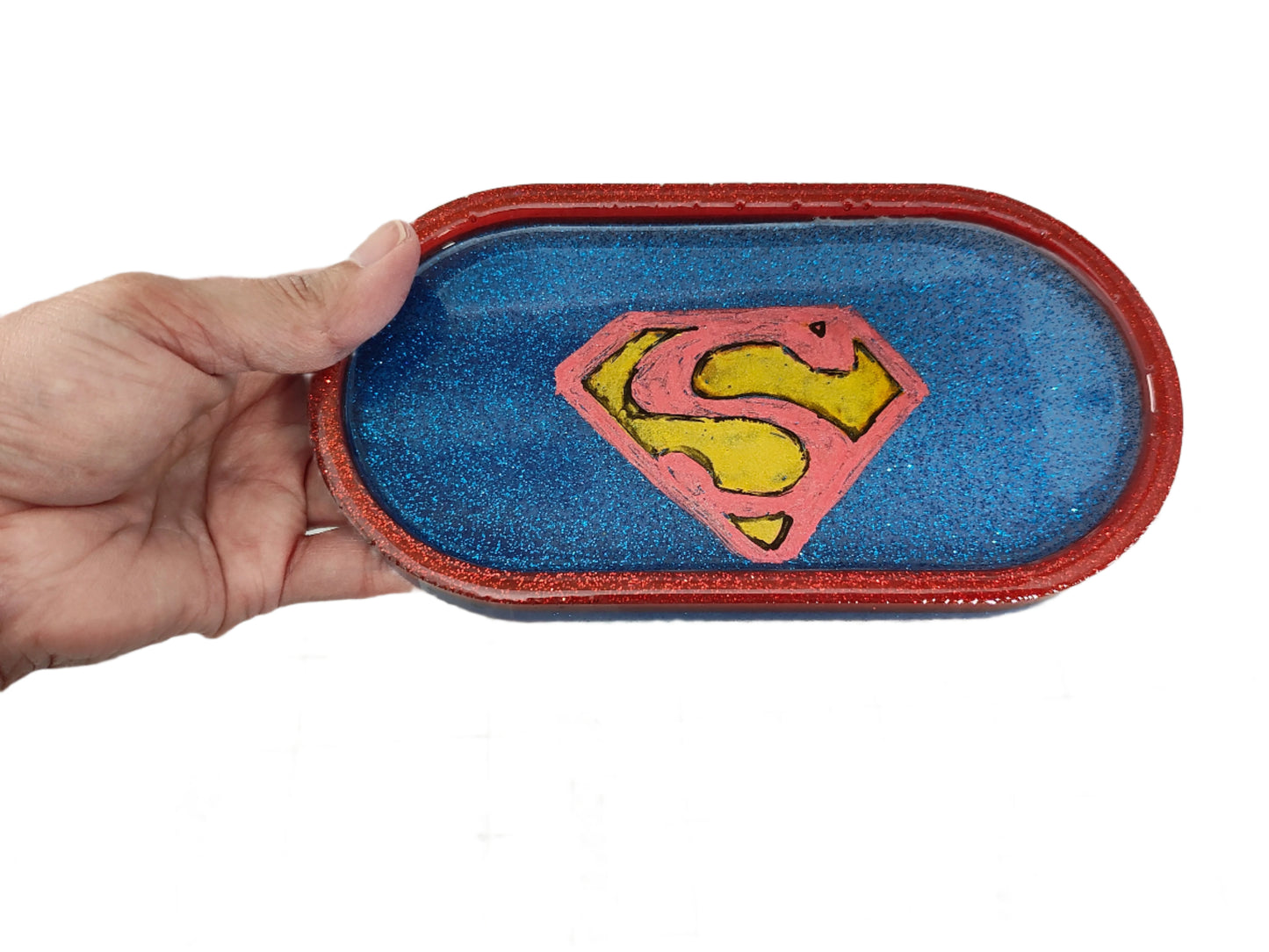 This Knickknack trinket dish not only adds a fun touch to any space with its super hero theme, but also serves as a functional and stylish storage option for small items. Made of durable resin, it is designed to keep jewelry, change, and other trinkets organized and easily accessible.