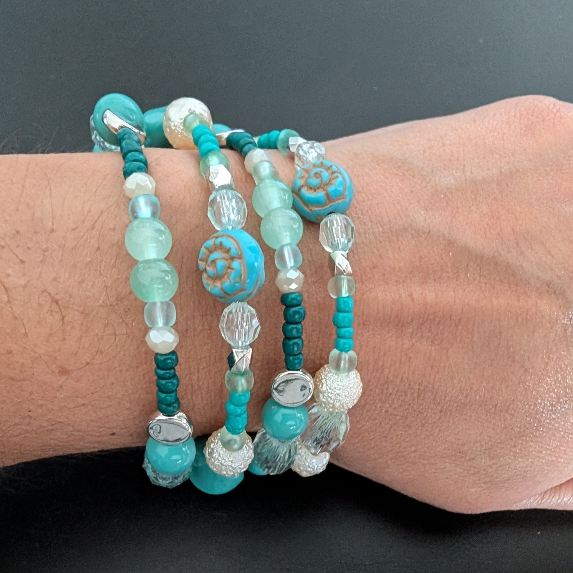 Elevate your style with this stunning 4-coil memory wire bracelet featuring a harmonious blend of turquoise, white, and crystal beads. Its flexible design ensures a comfortable fit for any wrist, while the sparkling crystals add a touch of elegance to any outfit. Perfect for layering or wearing alone, this bracelet effortlessly combines durability with eye-catching beauty.