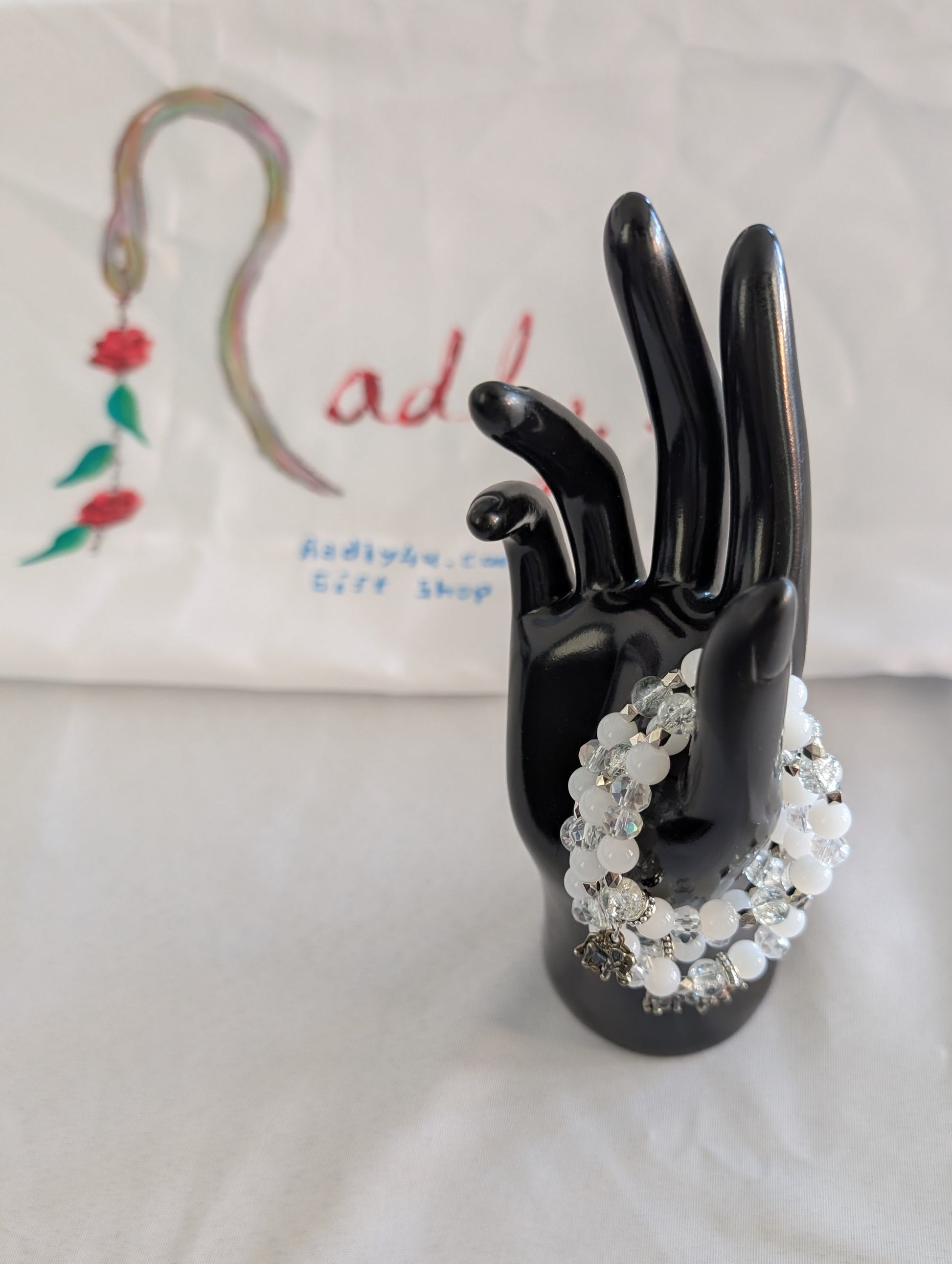 Celebrate wisdom and grace with this luminous elastic bracelet featuring a charming silver elephant charm. Strung with 8mm white and clear beads that sparkle with crystal and glass accents, complemented by delicate silver spacers, this piece radiates understated elegance. The elastic design stretches to fit comfortably on any wrist—no clasps needed—making it perfect for everyday wear or stacking with your favorite bracelets. At just 0.50 oz, it's lightweight enough to wear all day without fatigue. Whether y