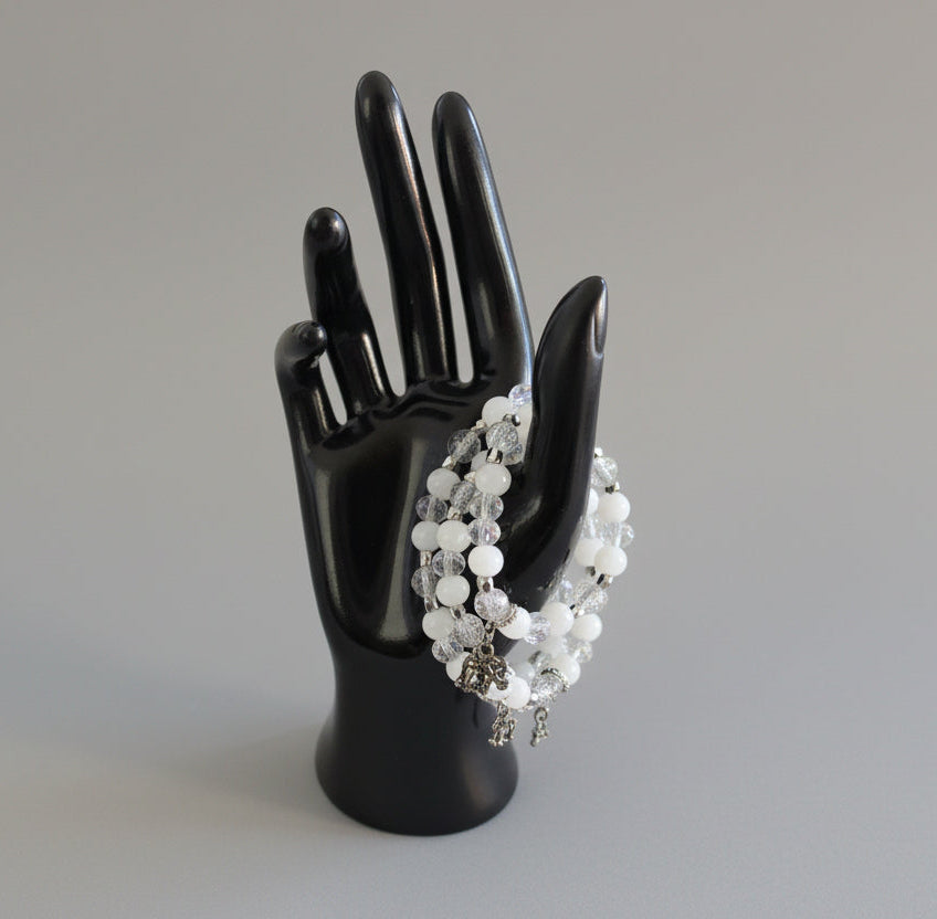 Celebrate wisdom and grace with this luminous elastic bracelet featuring a charming silver elephant charm. Strung with 8mm white and clear beads that sparkle with crystal and glass accents, complemented by delicate silver spacers, this piece radiates understated elegance. The elastic design stretches to fit comfortably on any wrist—no clasps needed—making it perfect for everyday wear or stacking with your favorite bracelets. At just 0.50 oz, it's lightweight enough to wear all day without fatigue. Whether y