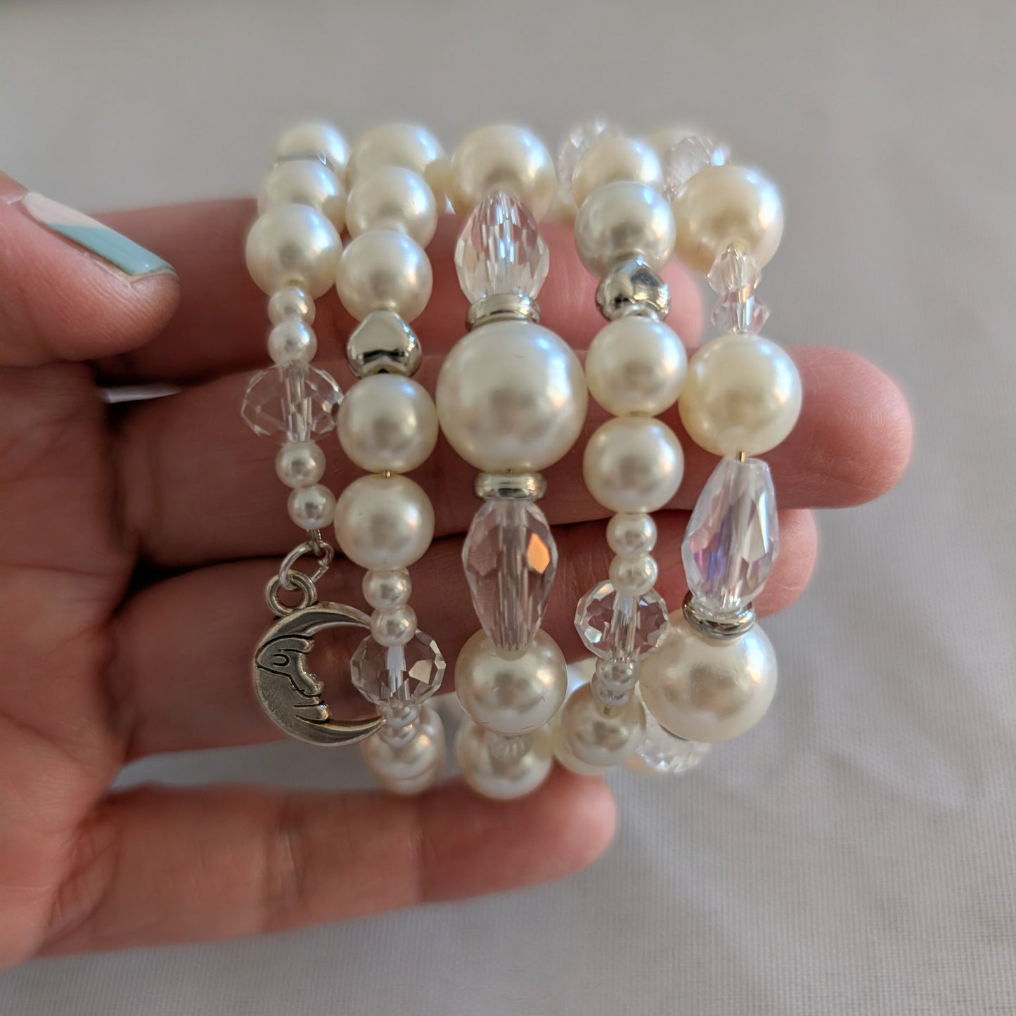 Experience elegance with our Memory Wire Bracelet featuring white pearl beads and silver spacer beads. Enhance any outfit with this versatile and stylish piece. Feel confident and glamorous with every wear!