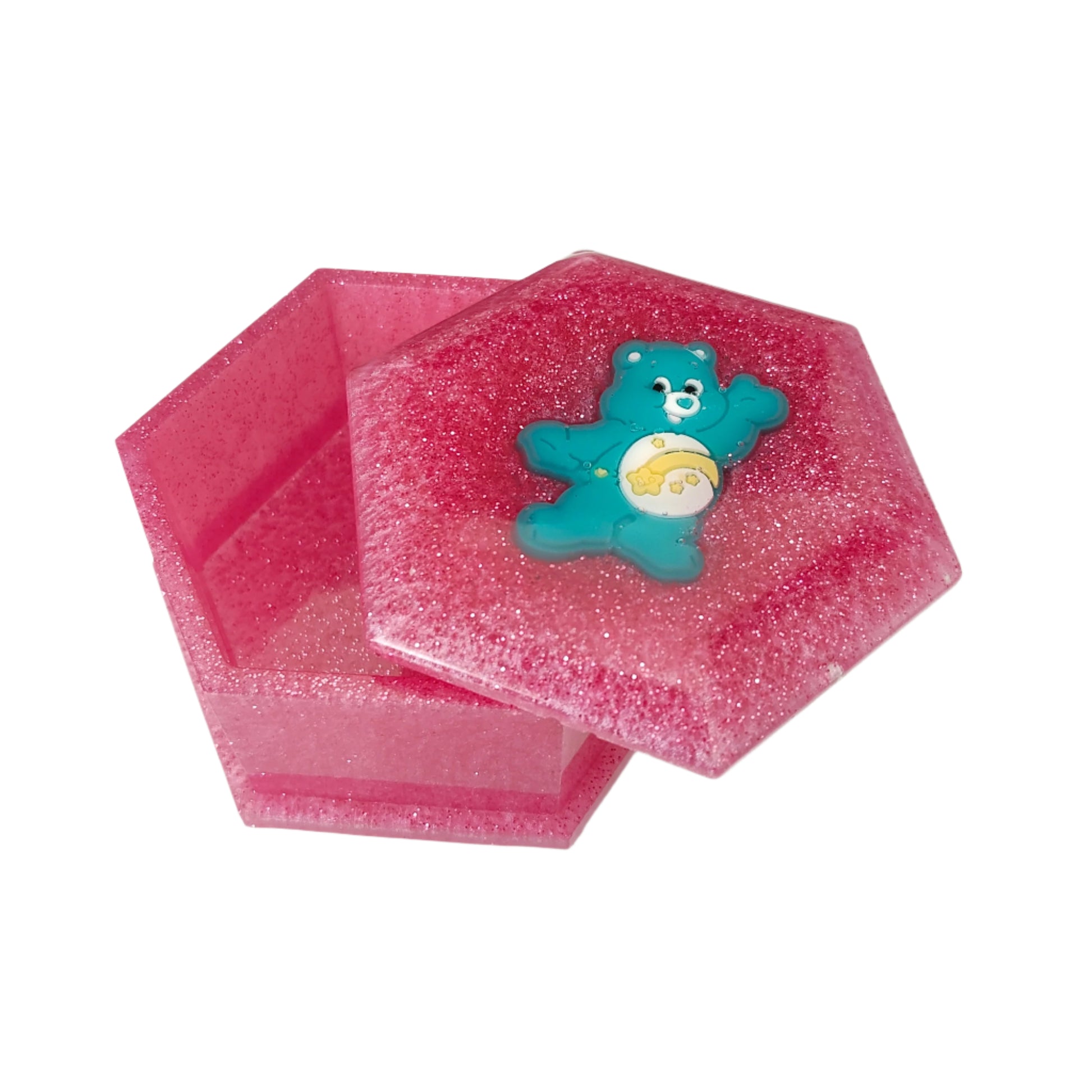 Add a touch of whimsy to your jewelry collection with our Knickknack Resin Hexagon Jewelry Box. The character lid adds a playful element to your storage, while the resin material ensures durability and protection for your precious pieces. Keep your jewelry safe and organized with this unique and charming box.
