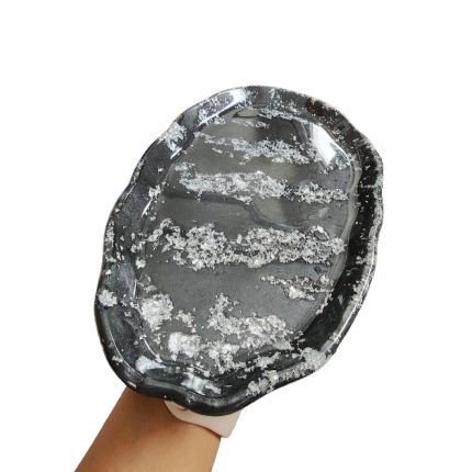 This trinket dish is the perfect way to store and display your favorite trinkets and treasures. The large, wavy oval design adds a unique touch to any space, while the durable resin material ensures long-lasting use. Keep your belongings organized and beautifully showcased with this must-have accessory!