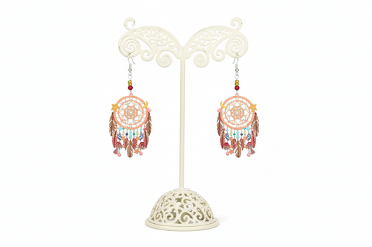 A pair of dream catcher earrings with beads, featuring a silver hook and intricate filigree design, predominantly in pink and multicolor tones.