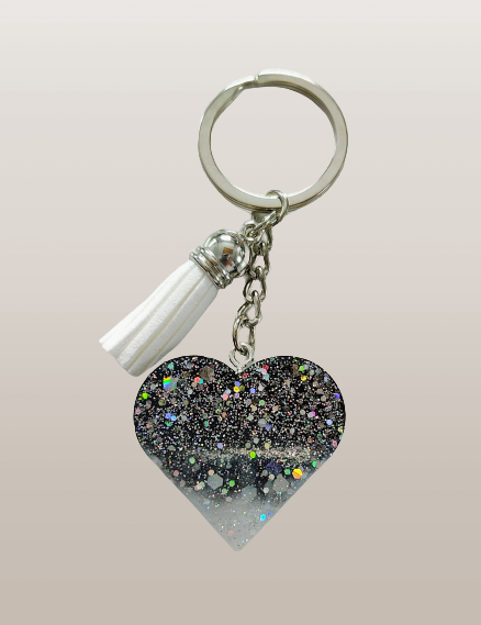 Show your heart is in the right place with this one-of-a-kind keychain! Its resin heart design is as unique as it is eye-catching – no two are alike. Plus, it's lightweight, making it perfect for carrying everywhere you go. Get your keychain on!