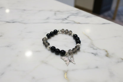 Elevate your everyday style with this stunning elastic bracelet featuring lustrous 8mm black beads paired with shimmering crystal and glass accents. Delicate silver spacer beads guide your eye to the centerpiece—an elegant silver butterfly charm that symbolizes transformation and grace. Lightweight at just 0.53 oz, this versatile piece transitions seamlessly from casual to sophisticated, making it the perfect accessory for any occasion. The elastic design ensures a comfortable, adjustable fit for all wrist 