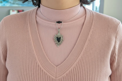 This elegant memory wire choker combines timeless style with modern sophistication. Featuring a striking black stainless steel heart pendant accented with lustrous black beads, it adjusts perfectly to fit neck sizes 4 to 4.5 inches. The durable .025" wire construction ensures lasting wear without losing its shape, while the lightweight design at just 0.28 oz makes it comfortable for all-day elegance. Whether layered with other pieces or worn solo, this versatile choker adds an instant touch of charm to any 