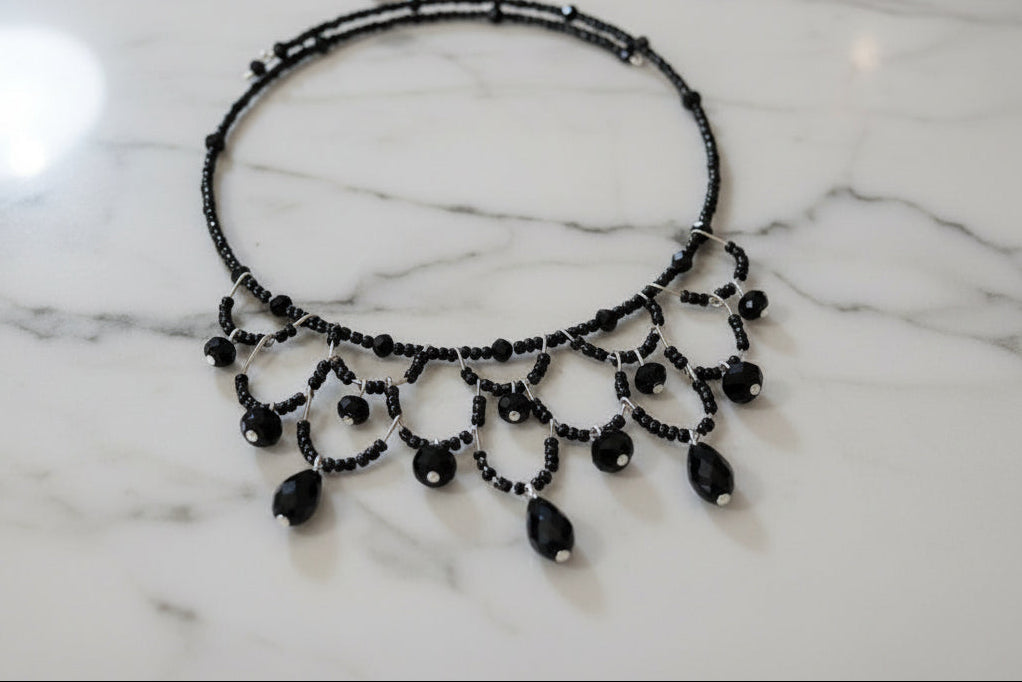 Make a bold statement with this striking black memory wire choker that effortlessly elevates any look. Adorned with shimmering crystal beads and delicate seed beads, this piece delivers sophisticated sparkle in a compact, wearable design. The memory wire construction automatically adjusts to fit your neck perfectly—no clasps or closures needed—while the ultra-lightweight 0.43 oz weight ensures all-day comfort. With a 4-4.5 inch coil diameter, it sits beautifully at the base of your neck for maximum impact. 