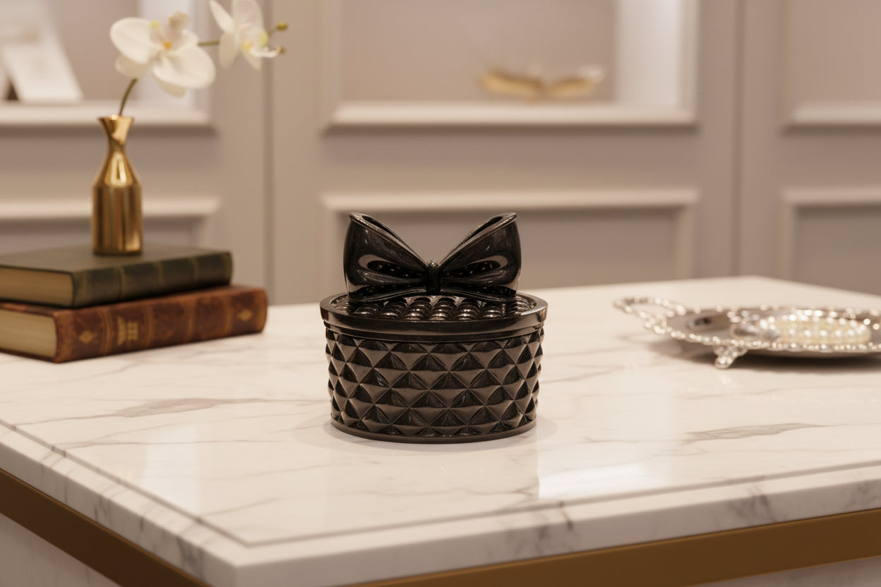 This beautifully crafted resin round trinket box with a bow lid is perfect for storing your delicate items. The intricate design adds a touch of elegance and sophistication to any room. Keep your trinkets safe and organized in this stylish and functional piece.