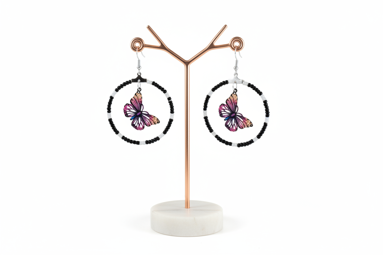 Add a touch of whimsy and elegance to your look with our Silver hoop earrings adorned with delicate seed beads and a beautiful filigree butterfly charm. These versatile earrings can take you from day to night, elevating any outfit with their unique design and stunning details. A must-have for any jewelry collection!