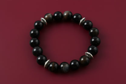 Experience the power of natural gemstones with our Black Stripe Agate Bracelet. The 6mm beads are expertly crafted for a comfortable elastic fit. The striking black stripes are complemented by silver spacer beads, adding a touch of elegance to this unique accessory. Feel confident and stylish with every wear!